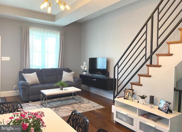 living room featuring a chandelier and dark hardwood / wood-style flooring