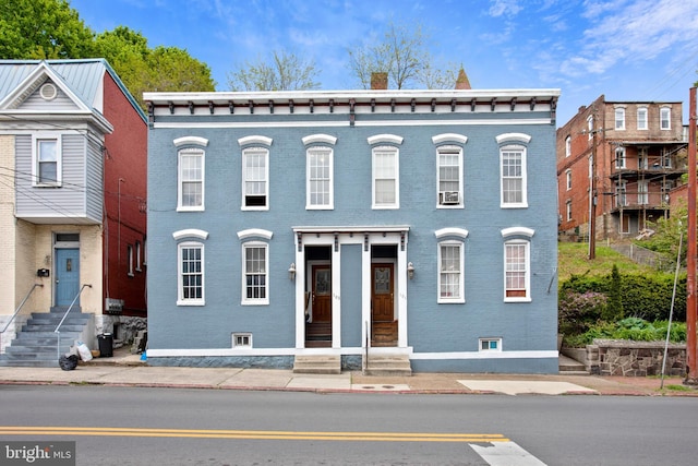 view of property featuring brick siding and entry steps