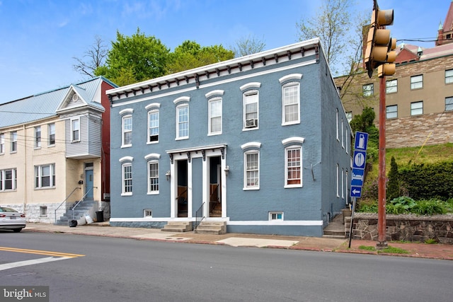 view of property featuring brick siding and entry steps