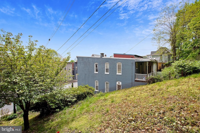 view of property exterior with a lawn