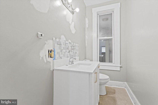 bathroom featuring vanity, toilet, and tile patterned flooring