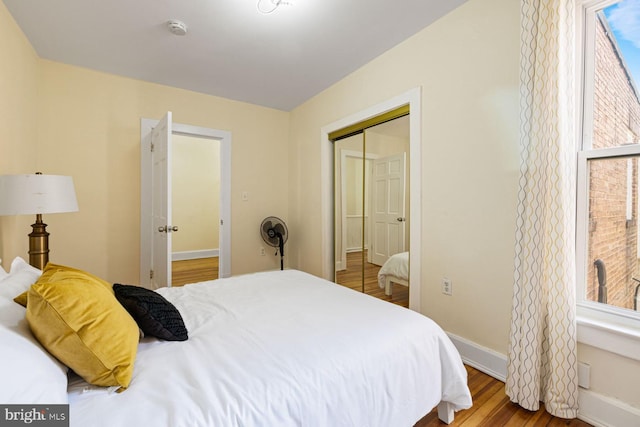 bedroom with hardwood / wood-style floors and a closet