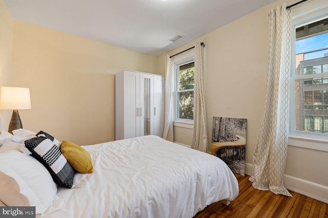 bedroom featuring dark wood-type flooring and a closet