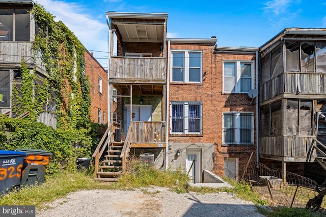 back of property with a balcony