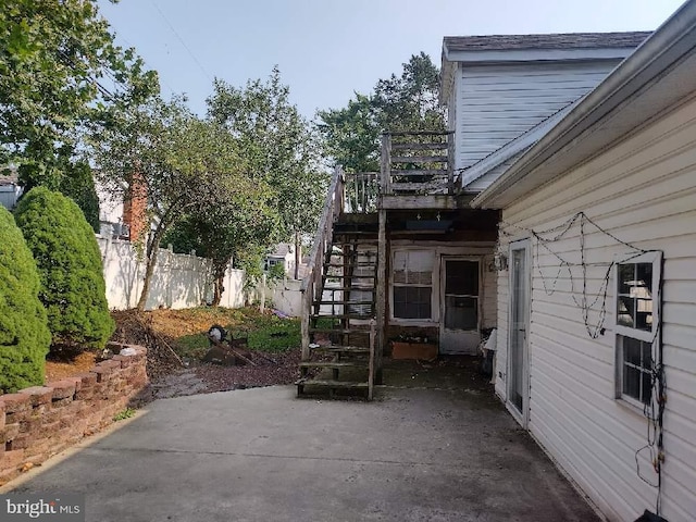 view of patio / terrace with stairs and fence