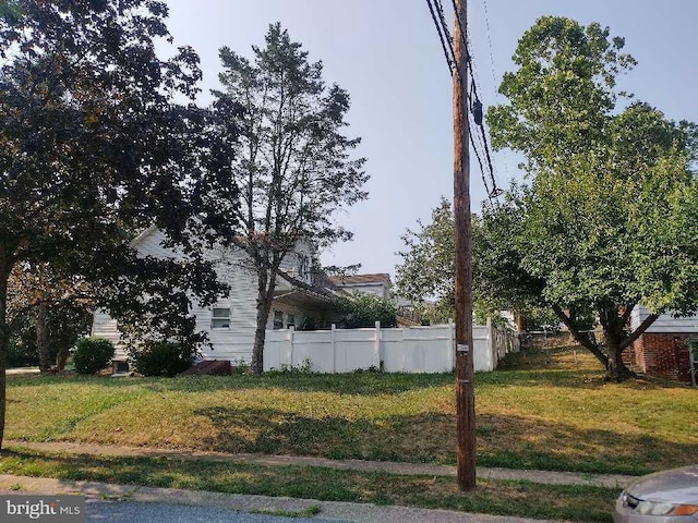 view of property exterior featuring a yard and fence