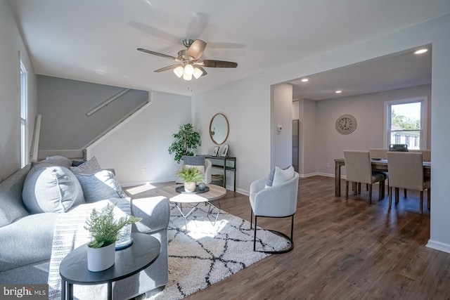 living room with dark wood-type flooring and ceiling fan