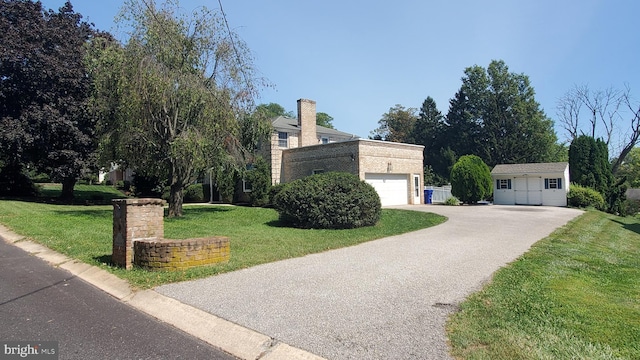 view of front of house featuring a front yard and a garage