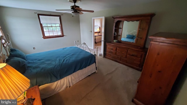 bedroom with light carpet and ceiling fan