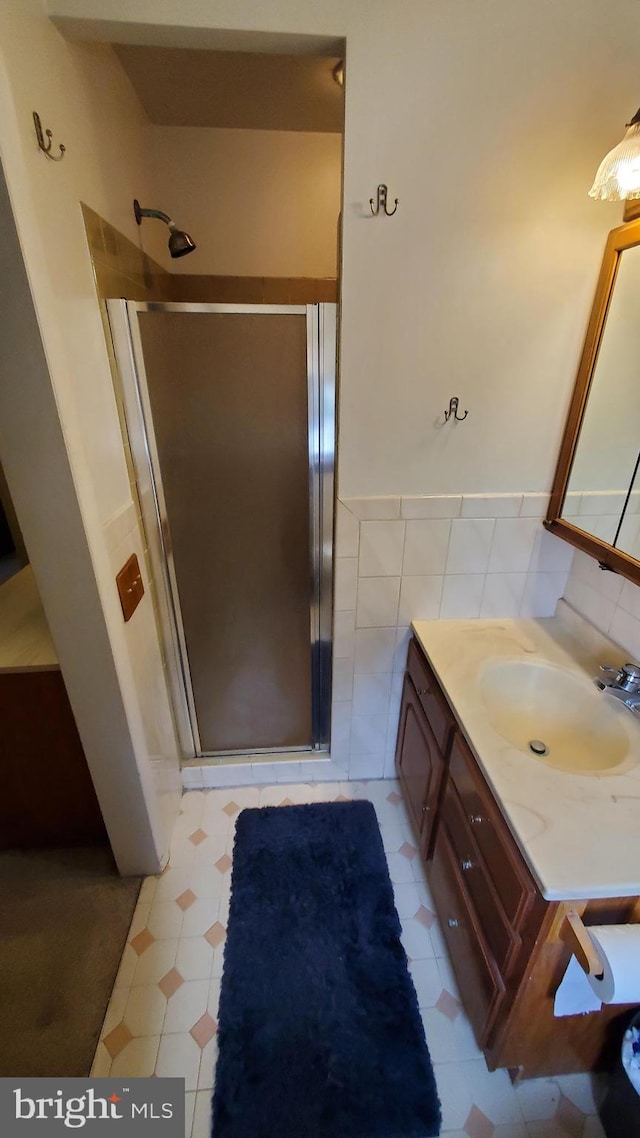 bathroom with walk in shower and vanity