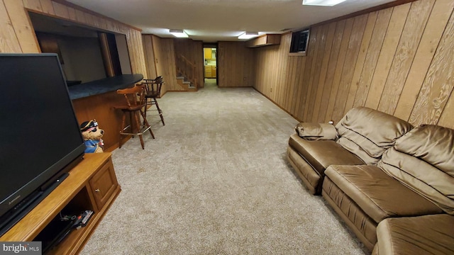 carpeted living room featuring indoor bar and wood walls