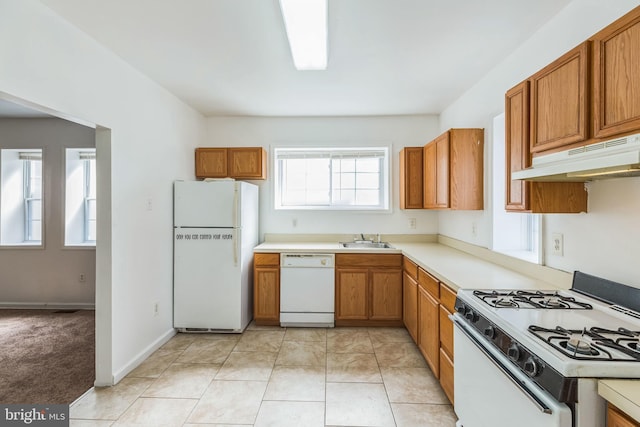 kitchen with sink, white appliances, and light tile patterned flooring