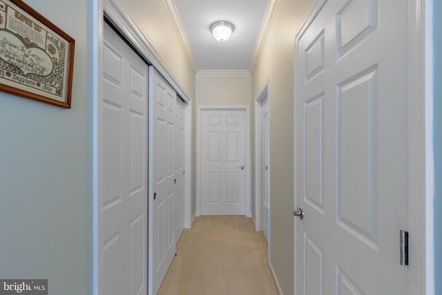 hallway featuring crown molding and light carpet