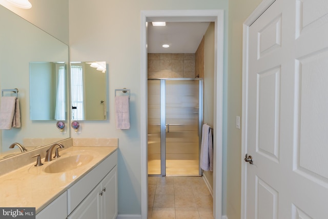 bathroom featuring vanity, a shower with shower door, and tile patterned flooring