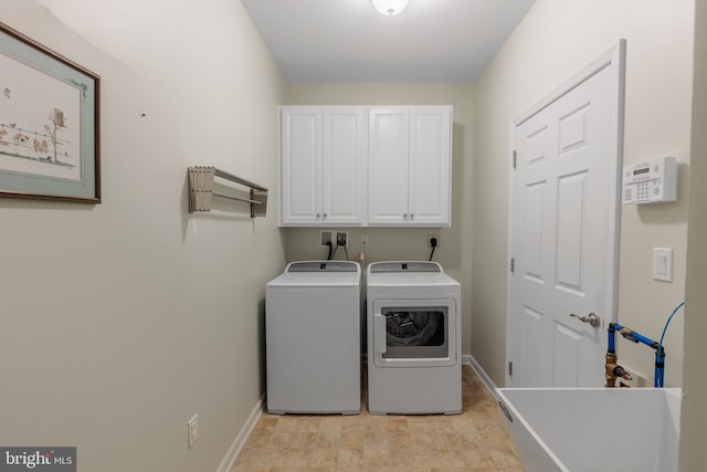 laundry area featuring cabinets, sink, and washer and clothes dryer