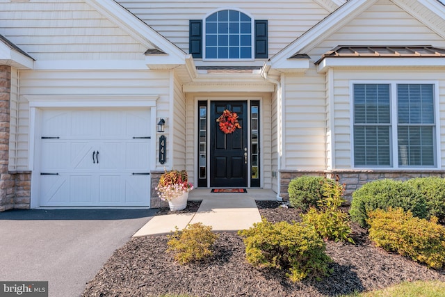 doorway to property with a garage