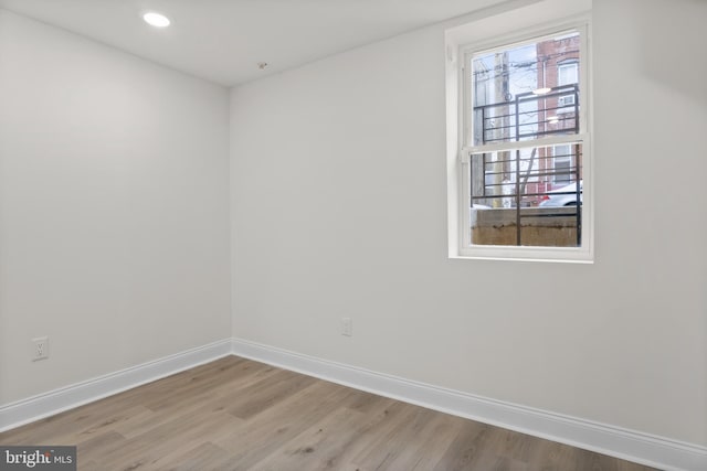 empty room with hardwood / wood-style floors