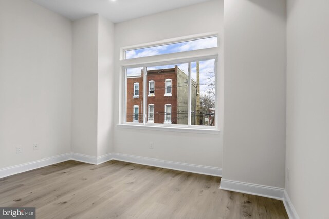 unfurnished room with light hardwood / wood-style floors