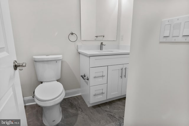 bathroom featuring toilet and vanity