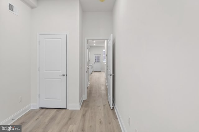 hall with light hardwood / wood-style floors