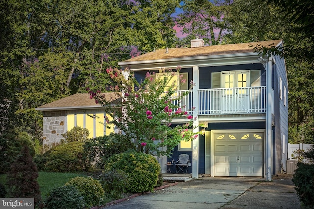 view of front of property featuring a balcony and a garage