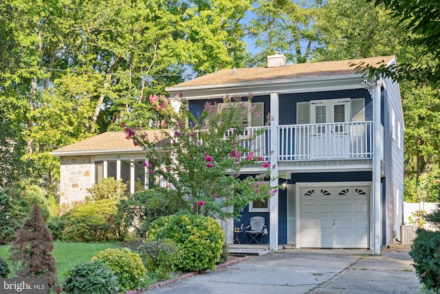 view of front facade featuring a balcony and a garage