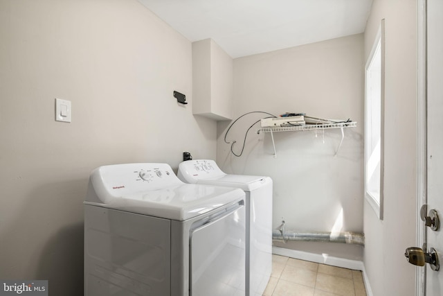 washroom with washer and dryer and light tile patterned floors