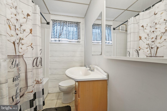 full bathroom with shower / bath combo with shower curtain, tile patterned flooring, vanity, and toilet