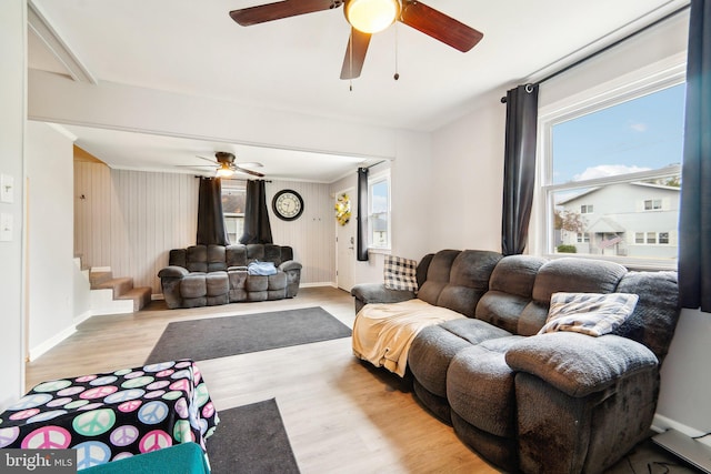 living room with light hardwood / wood-style flooring and ceiling fan