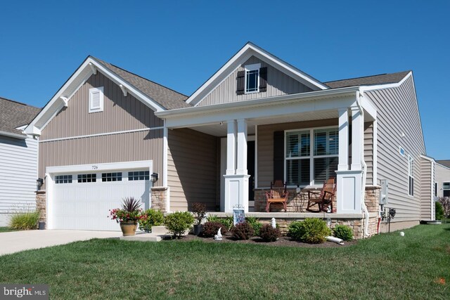 craftsman-style home featuring a garage, a front yard, and a porch