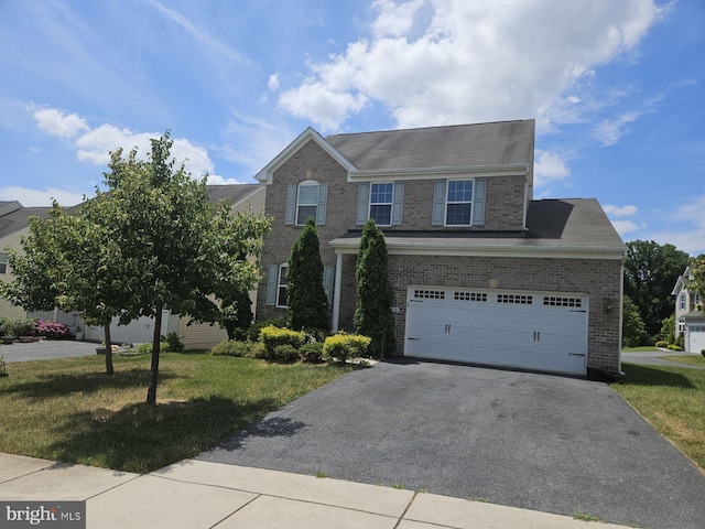 view of front of house with a garage and a front yard