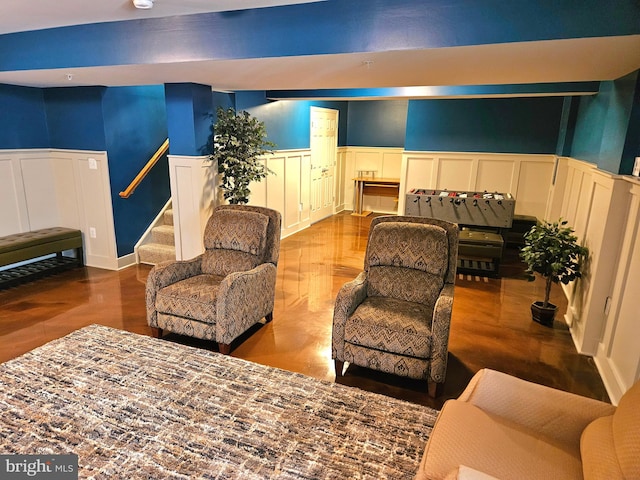 living room with a towering ceiling and hardwood / wood-style flooring