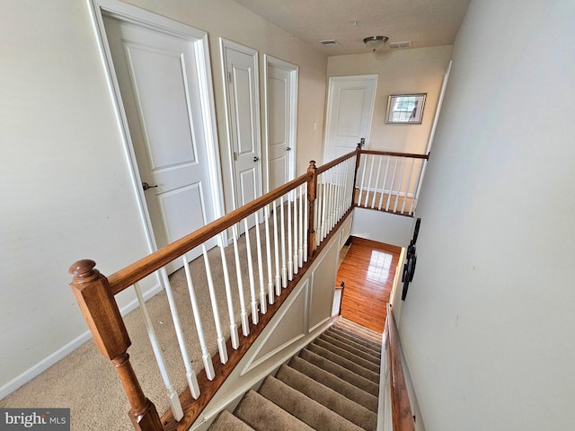 staircase featuring hardwood / wood-style flooring