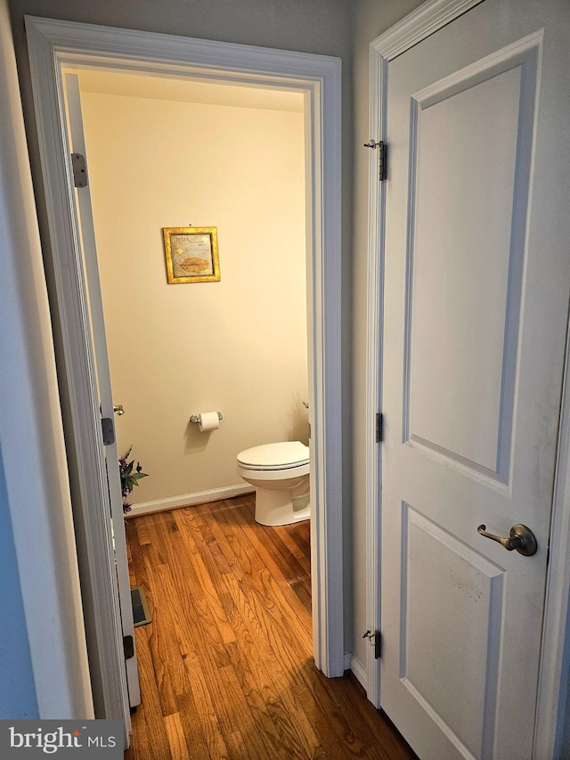 bathroom featuring toilet and hardwood / wood-style flooring