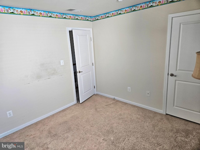 empty room featuring light colored carpet