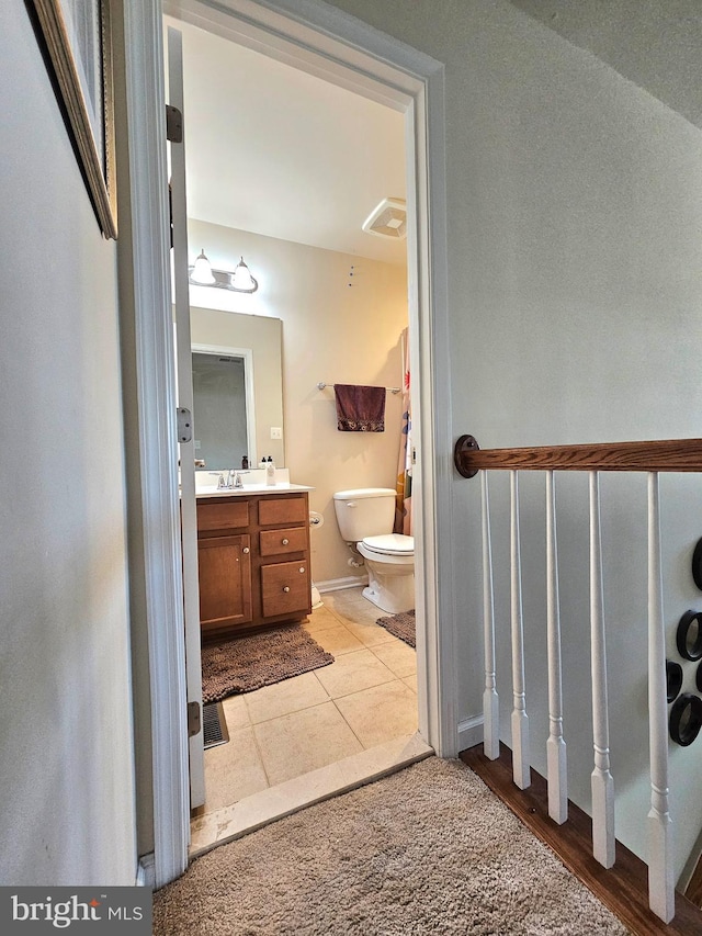 bathroom with tile patterned floors, toilet, and vanity