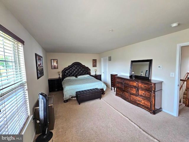 bedroom featuring lofted ceiling and carpet