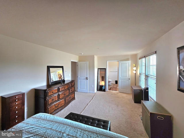 carpeted bedroom with ensuite bath