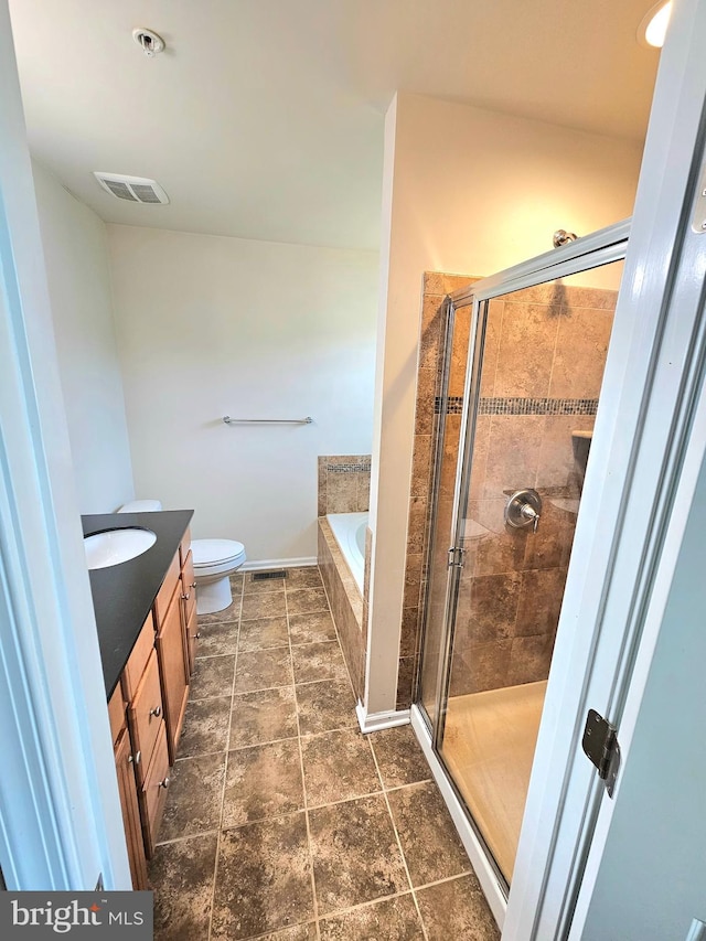 full bathroom featuring vanity, toilet, and separate shower and tub