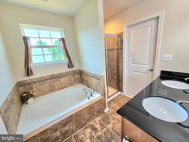 bathroom with vanity and separate shower and tub