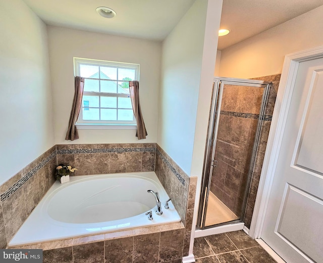 bathroom with shower with separate bathtub