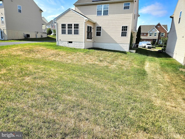 rear view of house with a yard and central air condition unit