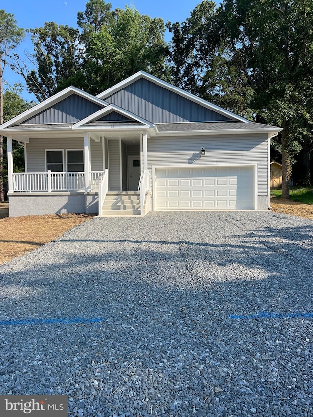 view of front of house featuring a porch and a garage