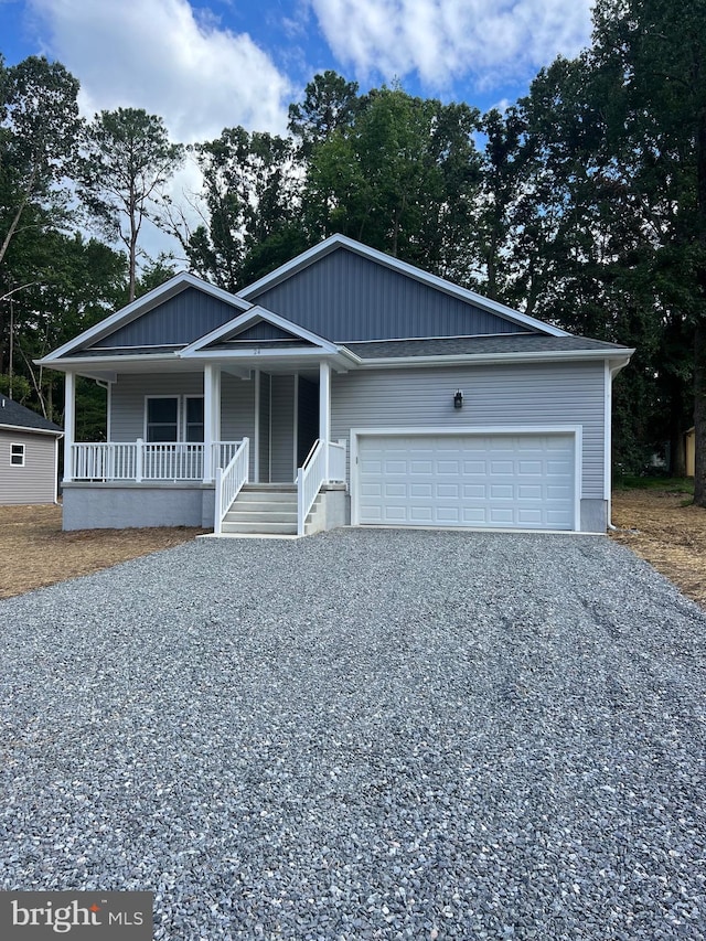 view of front of property featuring covered porch and a garage