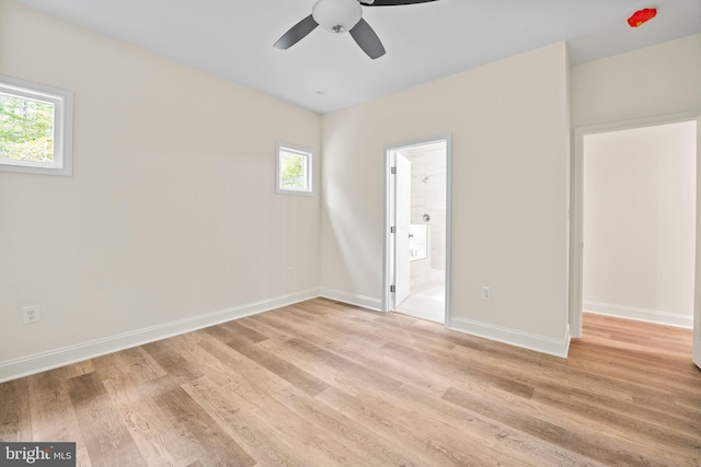 unfurnished bedroom with ensuite bath, light hardwood / wood-style flooring, and ceiling fan