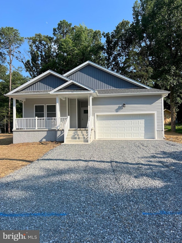 view of front of property featuring a garage and a porch