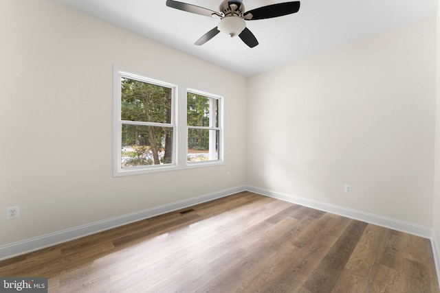 spare room with wood-type flooring and ceiling fan