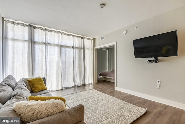 living room with a wealth of natural light and dark hardwood / wood-style flooring