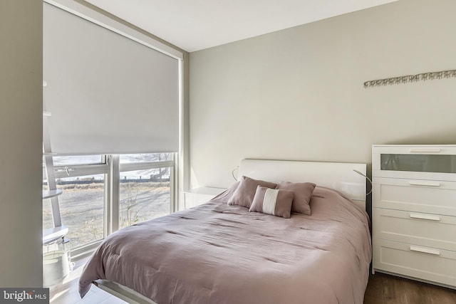 bedroom with dark hardwood / wood-style floors