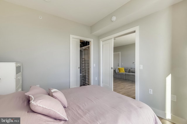 bedroom featuring hardwood / wood-style floors and a closet